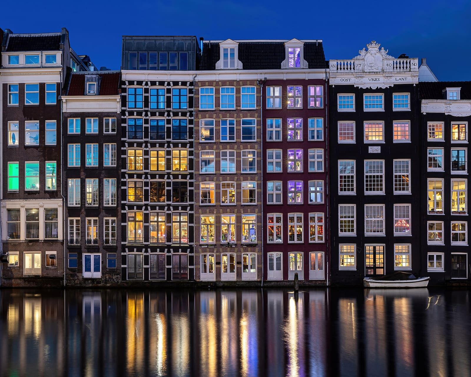 Canal houses reflected at blue hour in Amsterdam