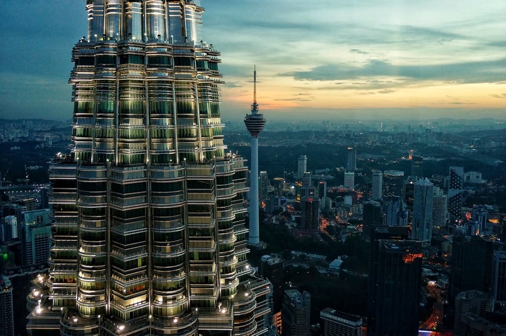 A Petronas Tower and the KL Tower over Kuala Lumpur at dusk