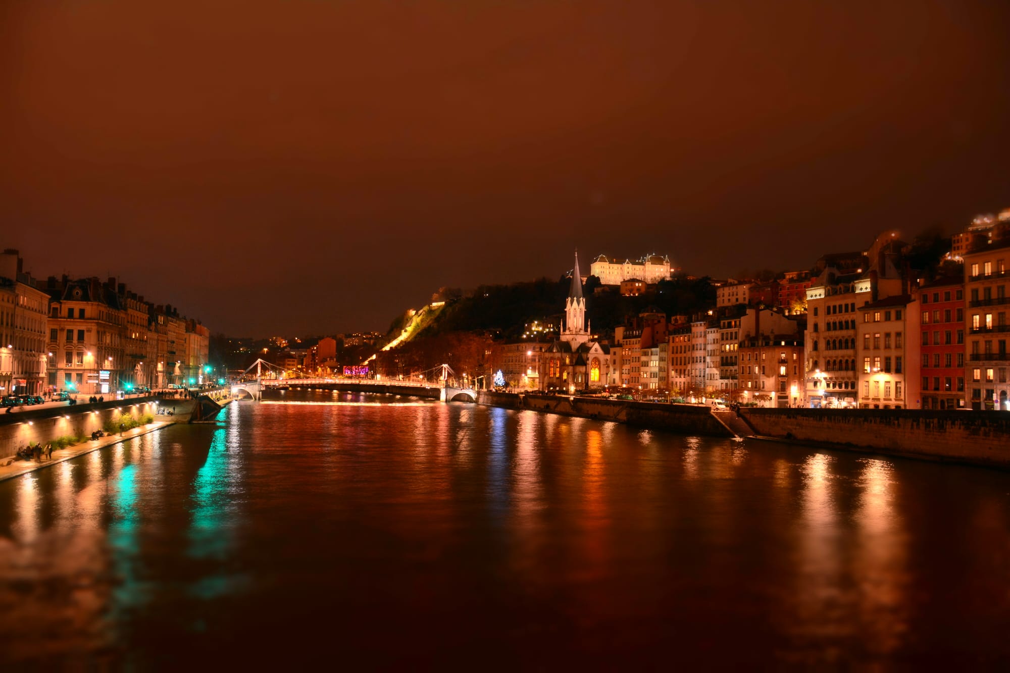Lyon's Saône quays lit at night below Fourvière